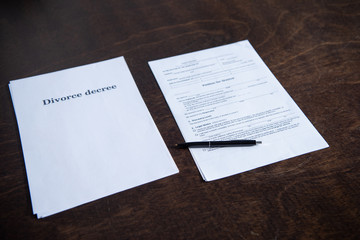 divorce documents and pen on brown wooden table