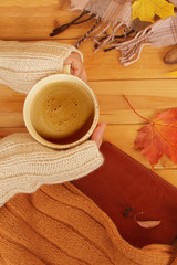 cup of hot fragrant coffee in the hands of a woman, autumn leaves, an apple, cozy scarves and knitted sweaters, an e-book, flat, the concept of a hugg, autumn mood, photography for story, social media