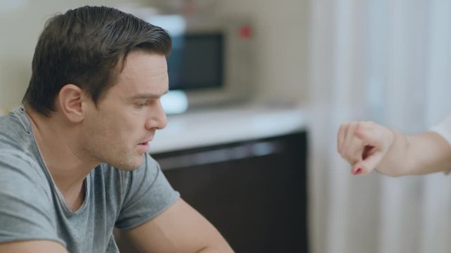 Closeup upset couple arguing at kitchen because of misunderstanding.