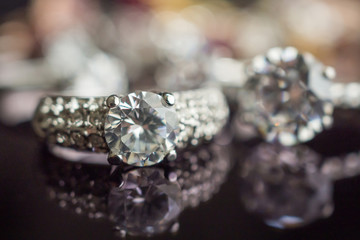 Jewelry wedding diamond rings on black background with reflection