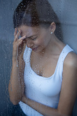 selective focus of stressed young woman crying at home