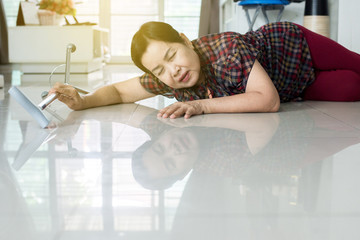 Senior asian woman suffering with faint lying on floor after falling down stair at home