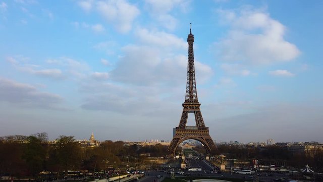 Eiffel Tower in Paris city with fast flying bird on cloudy morning skies. Royalty free Full HD stock footage for your projects related to France, French and European life, travel, culture.