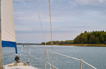 Coastline view from a sailing boat on a partly cloudy day