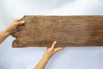 Hand holding wood for  Blank billboard design on the wood wall.