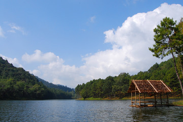 Fototapeta na wymiar A bamboo raft set in a lake surrounded by mountains and trees. It is a quiet and relaxing place. Pang Ung, Mae Hong Son, THAILAND.