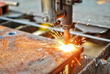 Cutting machine is starting to cut thick steel. Sparks and heat.