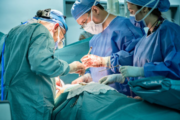 Medical team performing surgical operation in operating Room