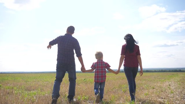 happy family walking nature teamwork friendship care concept slow motion video. lifestyle father mom and son walk in nature sunset sunlight hold hand. happy family parents man and girl hold little boy