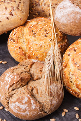 Wholegrain crunchy rolls for breakfast with seeds and ears of rye or wheat grain