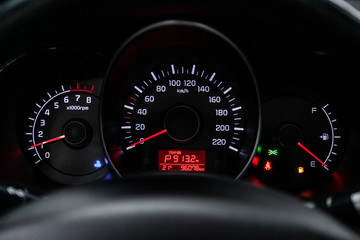 Car dashboard with white  backlight: Odometer, speedometer, tachometer, fuel level, water temperature and more.