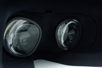 Closeup of fresnel lenses on a black virtual reality headset.