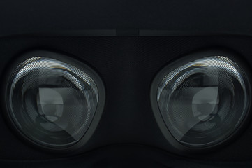 Closeup of fresnel lenses on a black virtual reality headset.