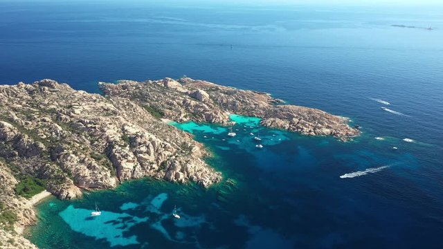 View from above, stunning aerial view of Cala Coticcio also known as Tahiti with boats and yachts floating on a turquoise clear water. La Maddalena Archipelago, Sardinia, Italy.