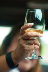 hand holding a glass of white wine