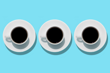 Cups with coffee on aquamarine background. Isolated. Top view.
