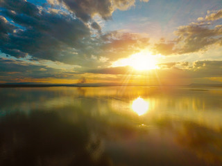 Beautiful Sunset in the sky with sky blue and orange light of the sun through the clouds in the sky, Orange and red dramatic colors over the sea - Image