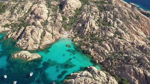 View from above, stunning aerial view of Cala Coticcio also known as Tahiti with boats and yachts floating on a turquoise clear water. La Maddalena Archipelago, Sardinia, Italy.