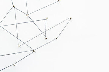 A large grid of pins connected with string. Communication, technology, network concept