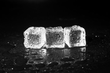 ice cubes on black table background.