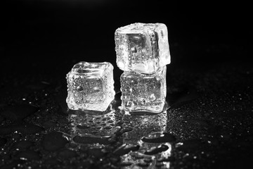 ice cubes on black table background.
