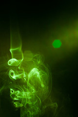 Green smoke motion on black background.