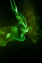 Green smoke motion on black background.