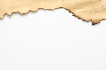 Cropped shot of old beige paper with burnt edge on white background. Decorative abstract art design. Copy space.