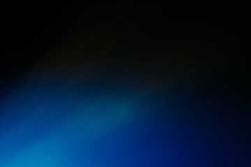 Defocused blue glow. Dark abstract art background. Colored lens flare light leak.