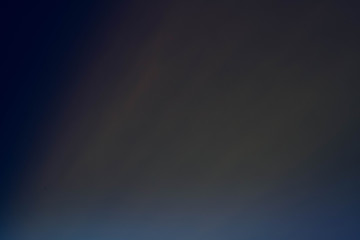 Smeared plum color glow. Dark abstract art background. Defocused lens flare light.
