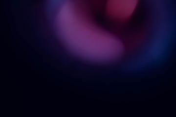 Blur purple and navy blue lights. Defocused dark abstract art background. Colored lens flare glow.