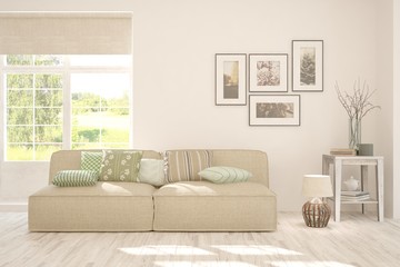 Stylish room in white color with sofa and summer landscape in window. Scandinavian interior design. 3D illustration