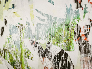 Fototapeta premium Layers of old colorful posters on wall damaged by time for your grunge style design