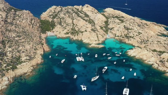 View from above, stunning aerial view of Cala Coticcio also known as Tahiti with boats and yachts floating on a turquoise clear water. La Maddalena Archipelago, Sardinia, Italy.