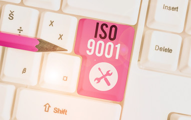 Text sign showing Iso 9001. Business photo showcasing designed help organizations to ensure meet the needs of customers White pc keyboard with empty note paper above white background key copy space