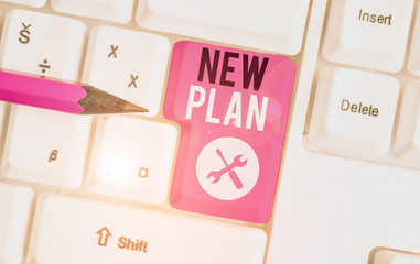 Text sign showing New Plan. Business photo showcasing Start of a detailed proposal of doing or achieving something White pc keyboard with empty note paper above white background key copy space