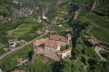 Fototapeta na wymiar Aerial view of vineyards in the Alps. Flying on drone. House on the rock.