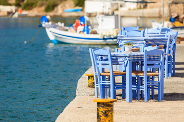 Open cafe outdoor restaurant in Greece on sea shore