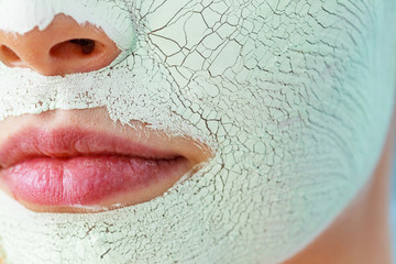 Girl with mud mask on face