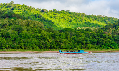Fototapeta na wymiar Beautiful green hills landscape with boat and rivers on blue sky background. decoration image contain certain grain noise and soft focus.