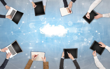 Group of people with devices in hands working on reports with online teamwork and cloud technology...