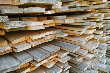 background of sawn boards in a stack. lumber at a sawmill or building materials store
