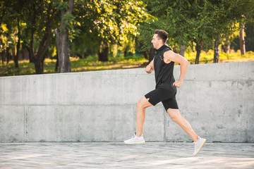 Sporty young man running outdoors