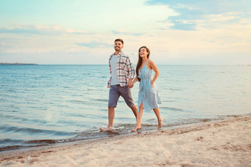 Happy couple running at sea resort