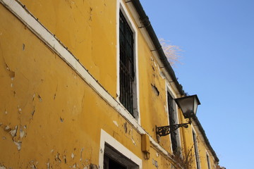 Obraz na płótnie Canvas Old building with peeling paint on a street of Seville