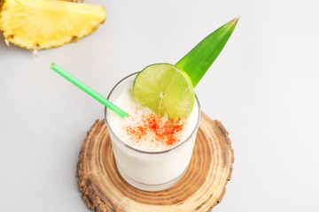Glass of tasty Pina Colada cocktail on table