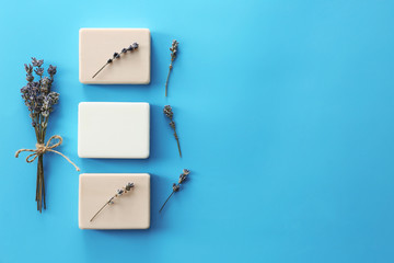 Soap bars with lavender on color background