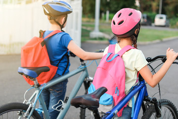 Naklejka premium Cute children riding bicycles outdoors