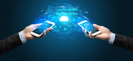Two mobile phones syncing through the cloud