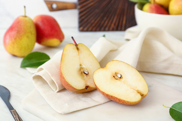 Naklejka na ściany i meble Tasty fresh pears on light table